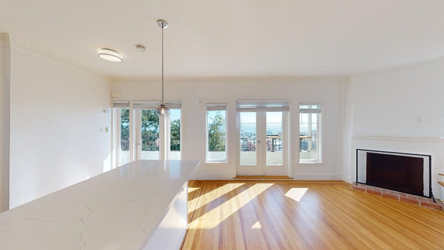 an empty living room with a tv and a fireplace
