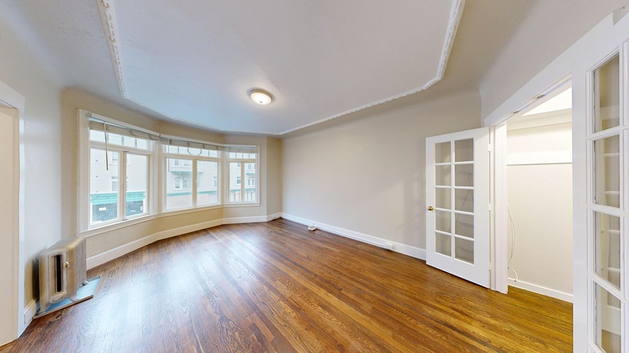 A room with wooden floors and white walls.