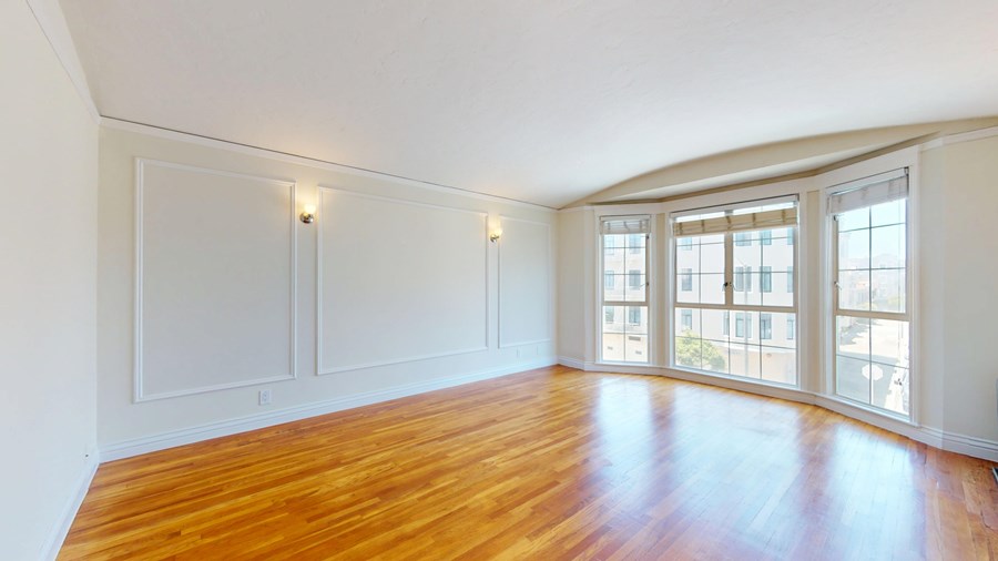 A room with wooden floors and white walls.