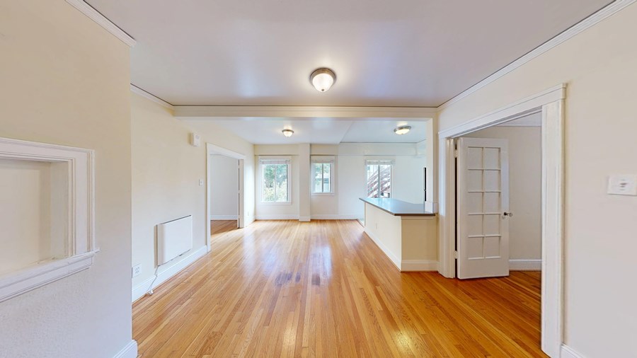 A room with wooden floors and white walls.