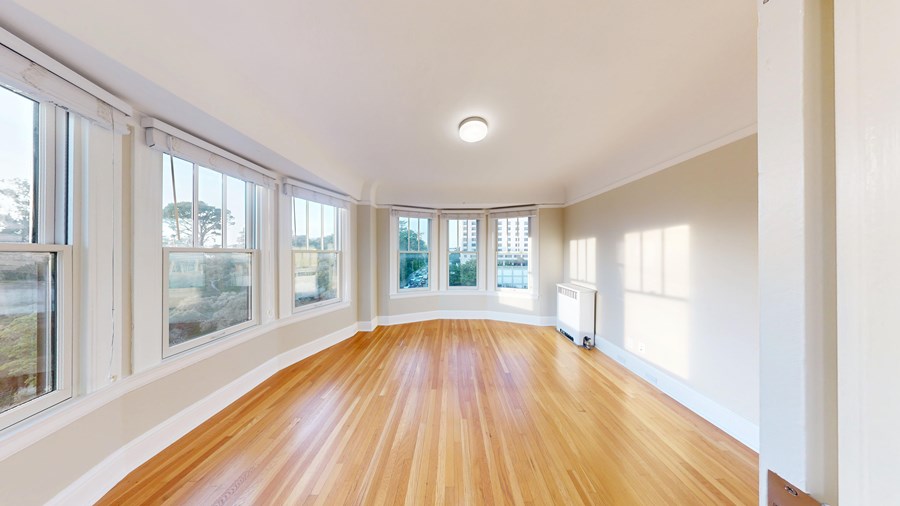 A room with wooden floors and white walls.