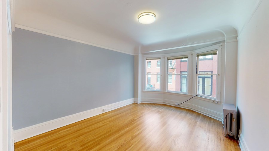 A room with wooden floors and a window.
