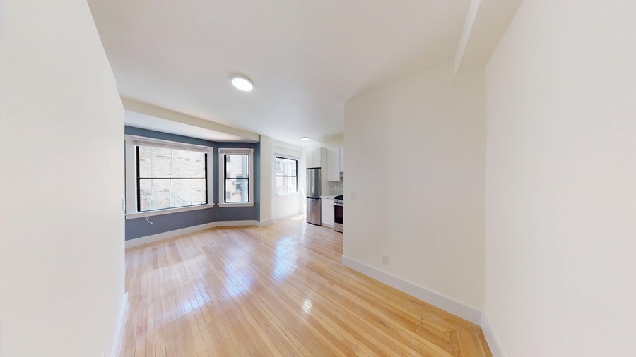 A room with wooden floors and white walls.