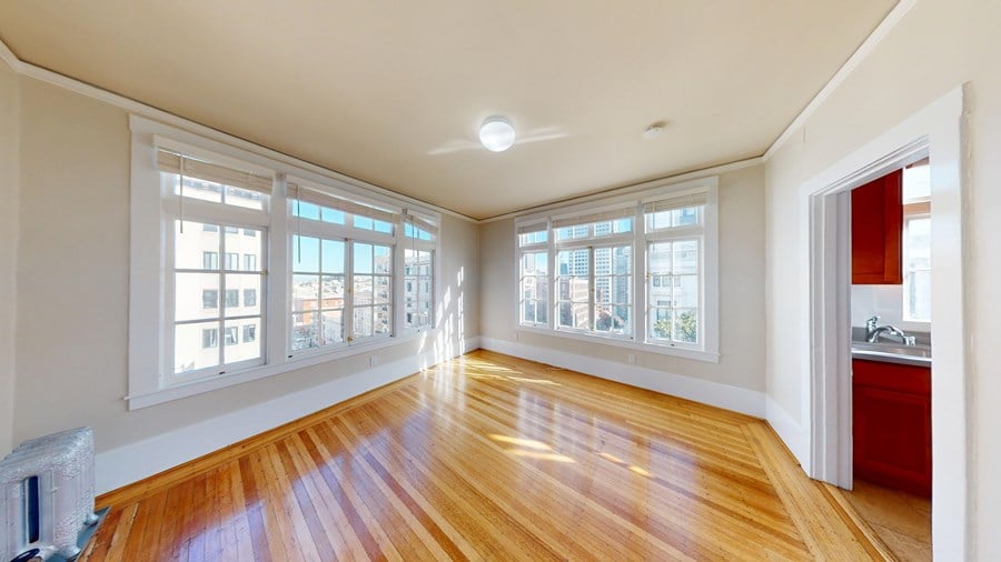 A room with wooden floors and white walls.