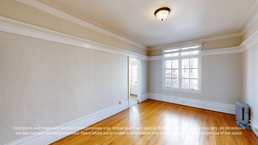 A room with a window and a wooden floor.
