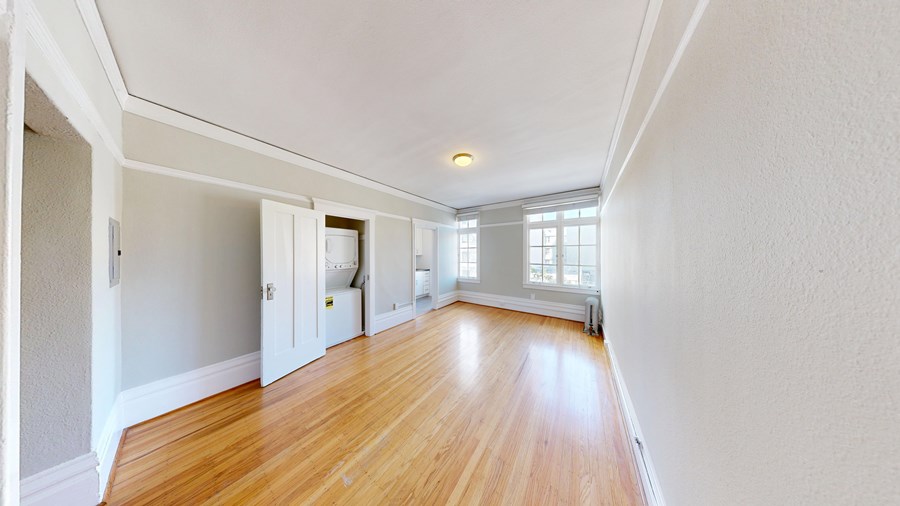 A room with wooden floors and white walls.