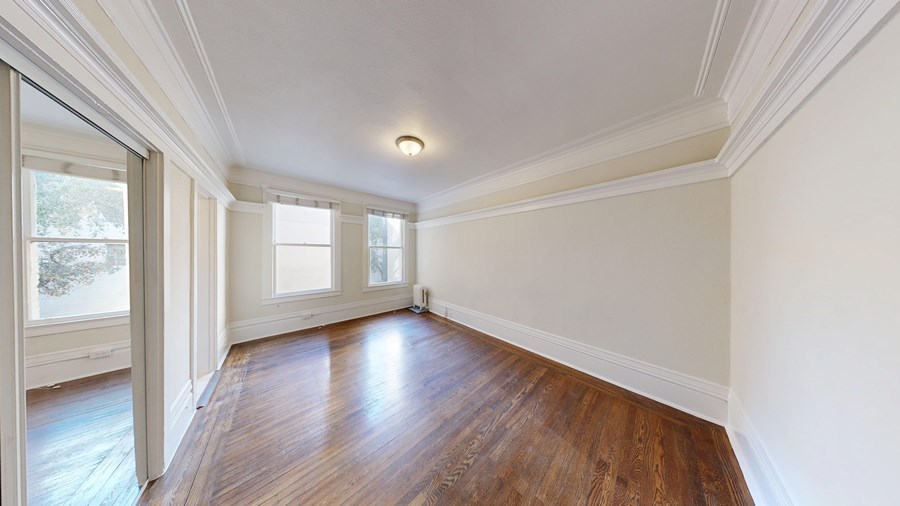 A room with wooden floors and white walls.