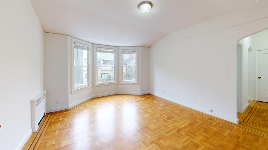 A room with wooden floors and white walls.