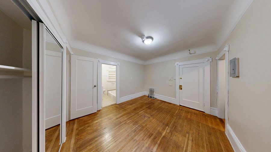 A room with wooden floors and white walls.