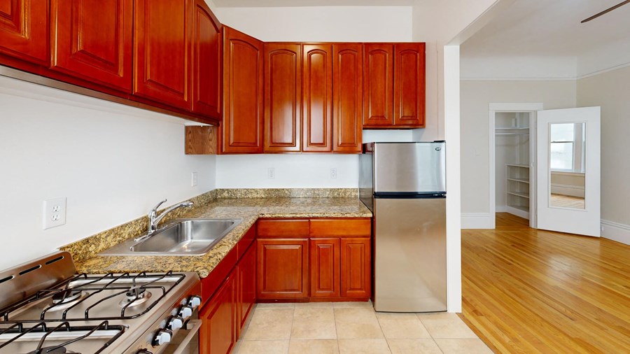 a kitchen with granite counter tops and stainless steel appliances