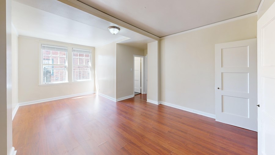 A room with wooden floors and white walls.