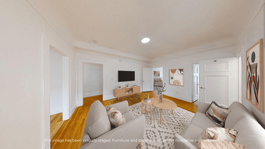 A living room with a grey couch and a wooden coffee table.