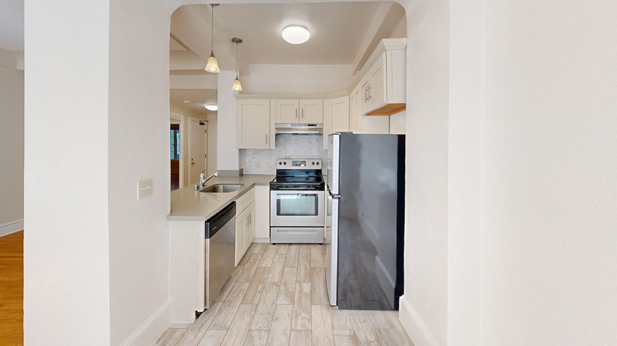 a kitchen with stainless steel appliances and white cabinets