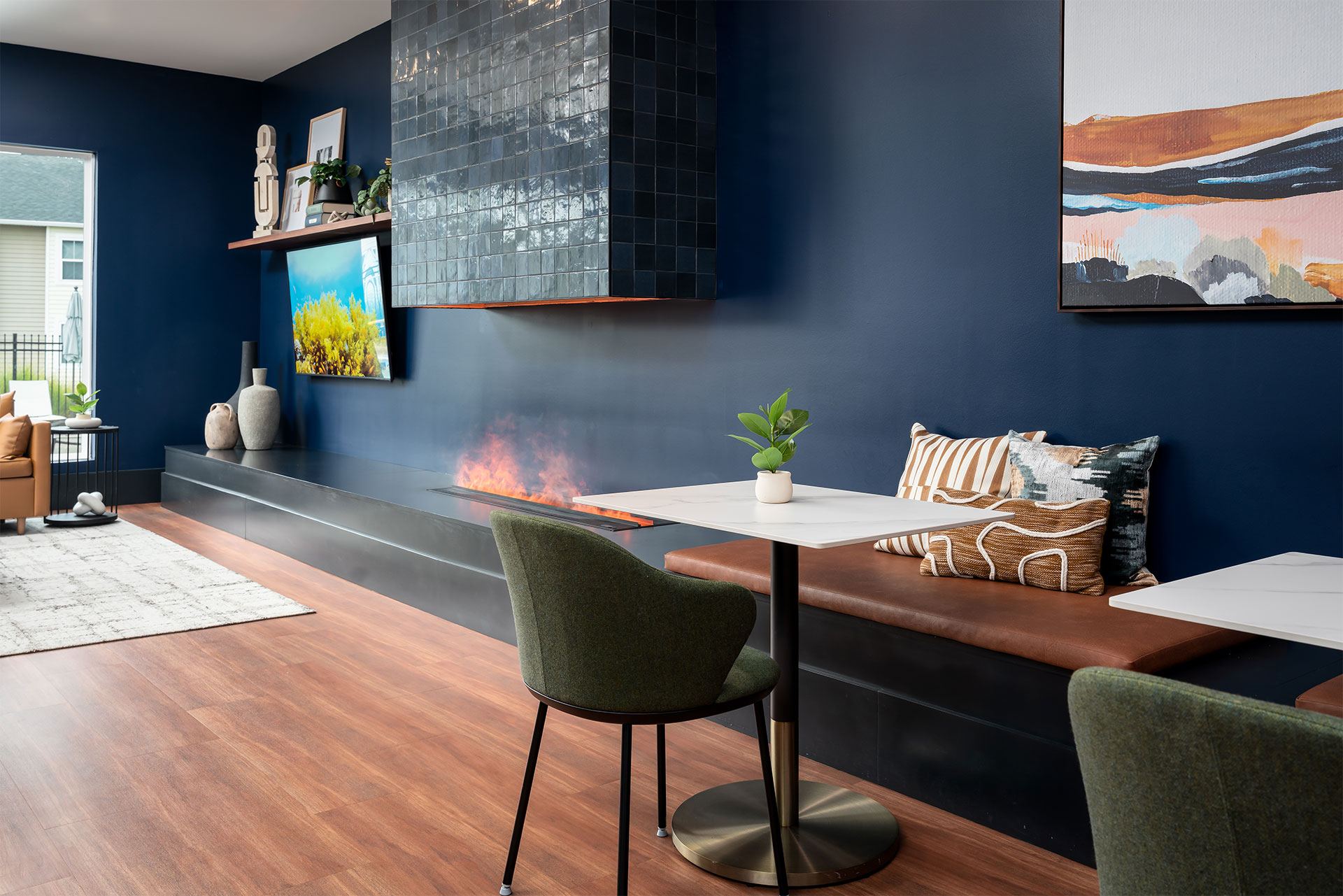A modern living room with a fireplace and a green chair.