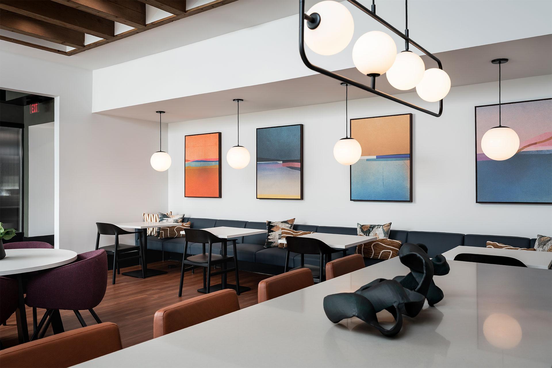 A modern dining room with a long table and chairs.