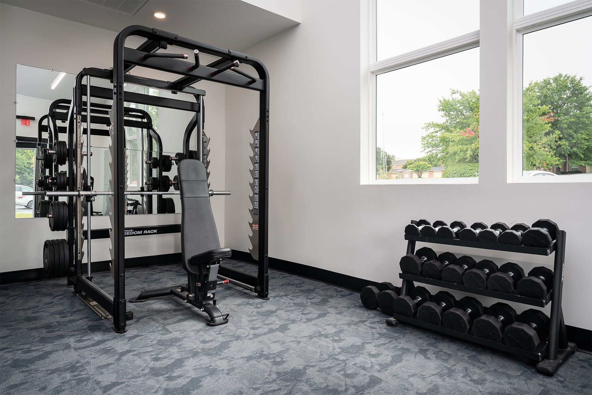 A gym with a weight bench and a multi-station weight machine.