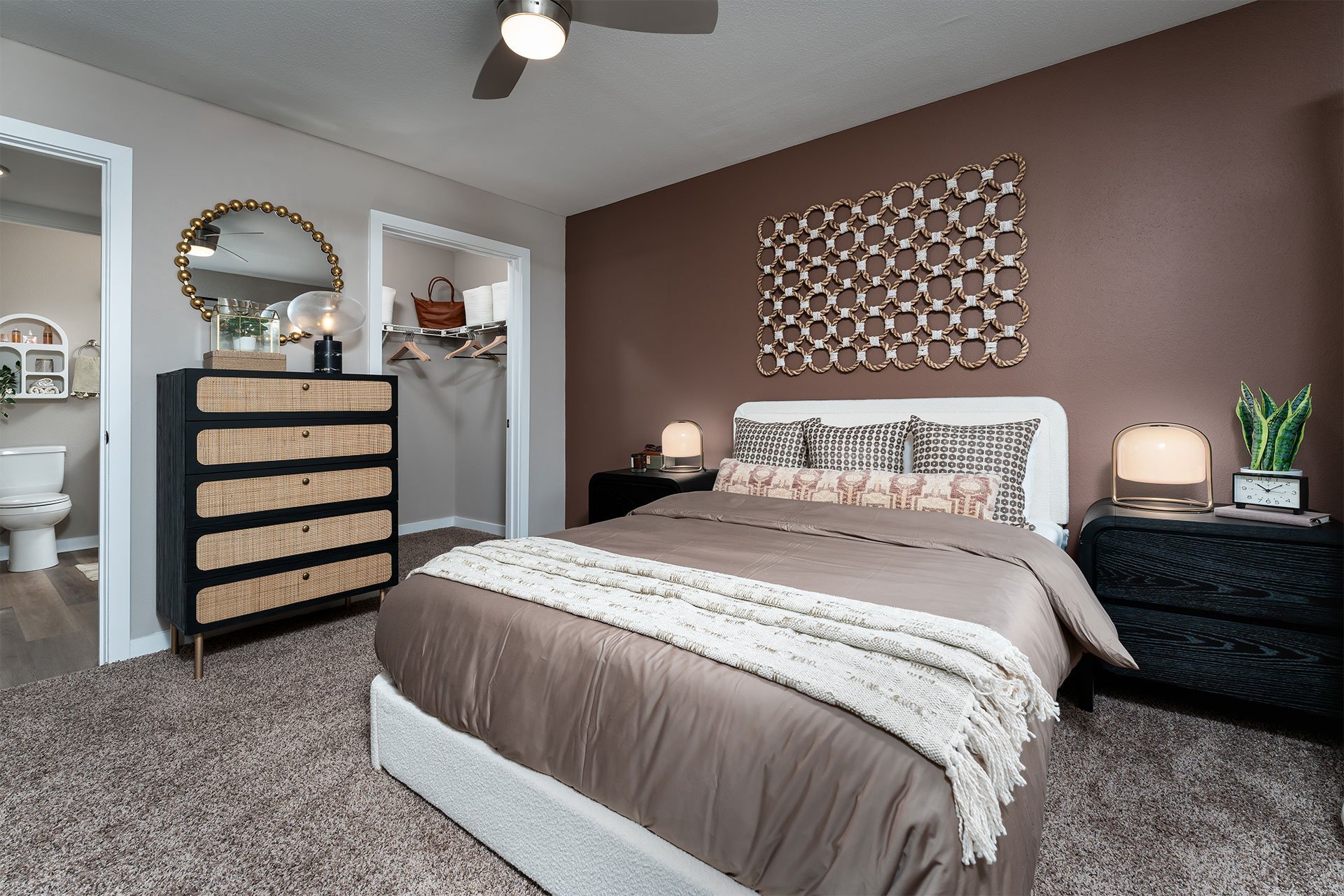 A bedroom with a bed, dresser, and mirror.