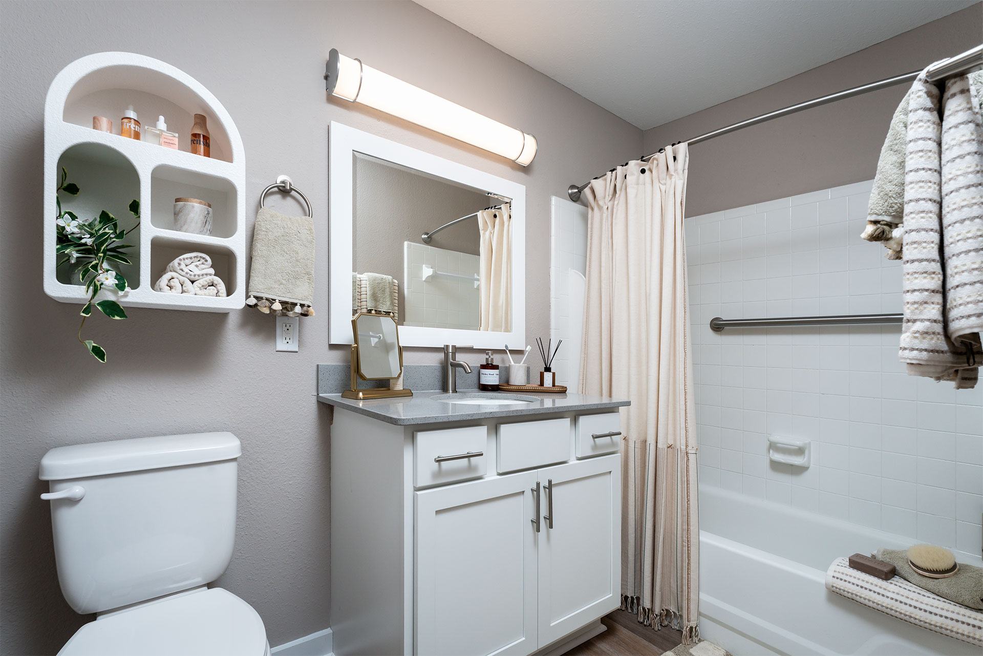 A white toilet sits next to a white sink in a bathroom.
