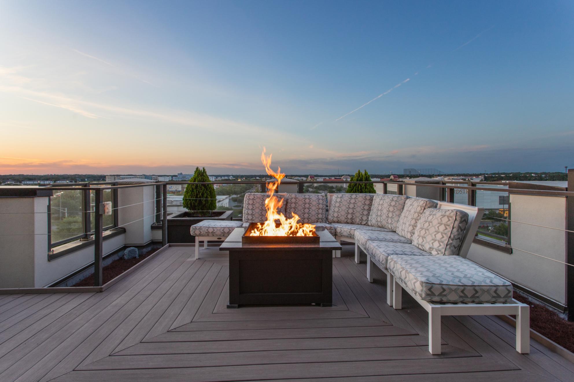 a patio with a fire pit on a roof