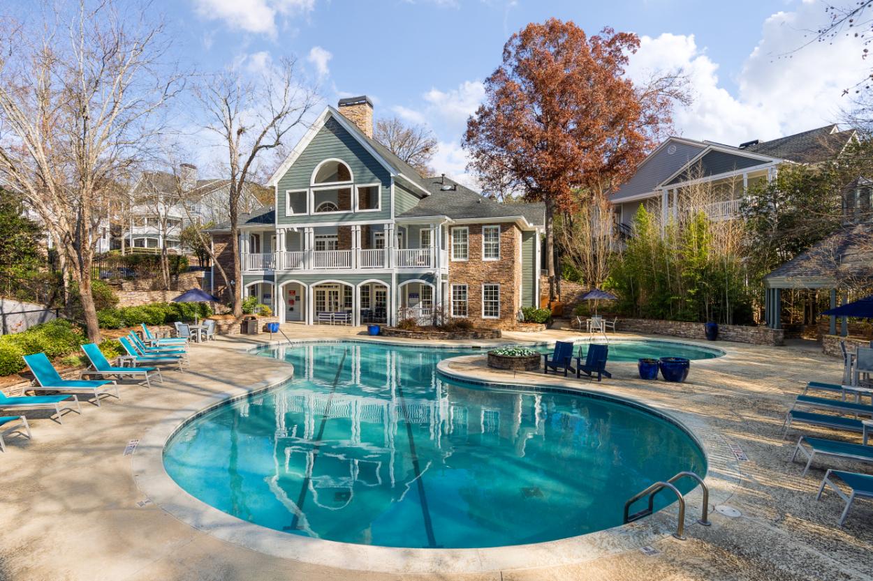 A large house with a pool in front.