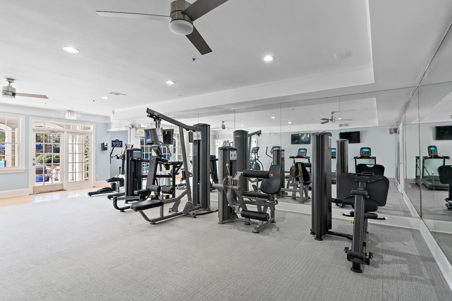 A spacious gym with a variety of equipment.