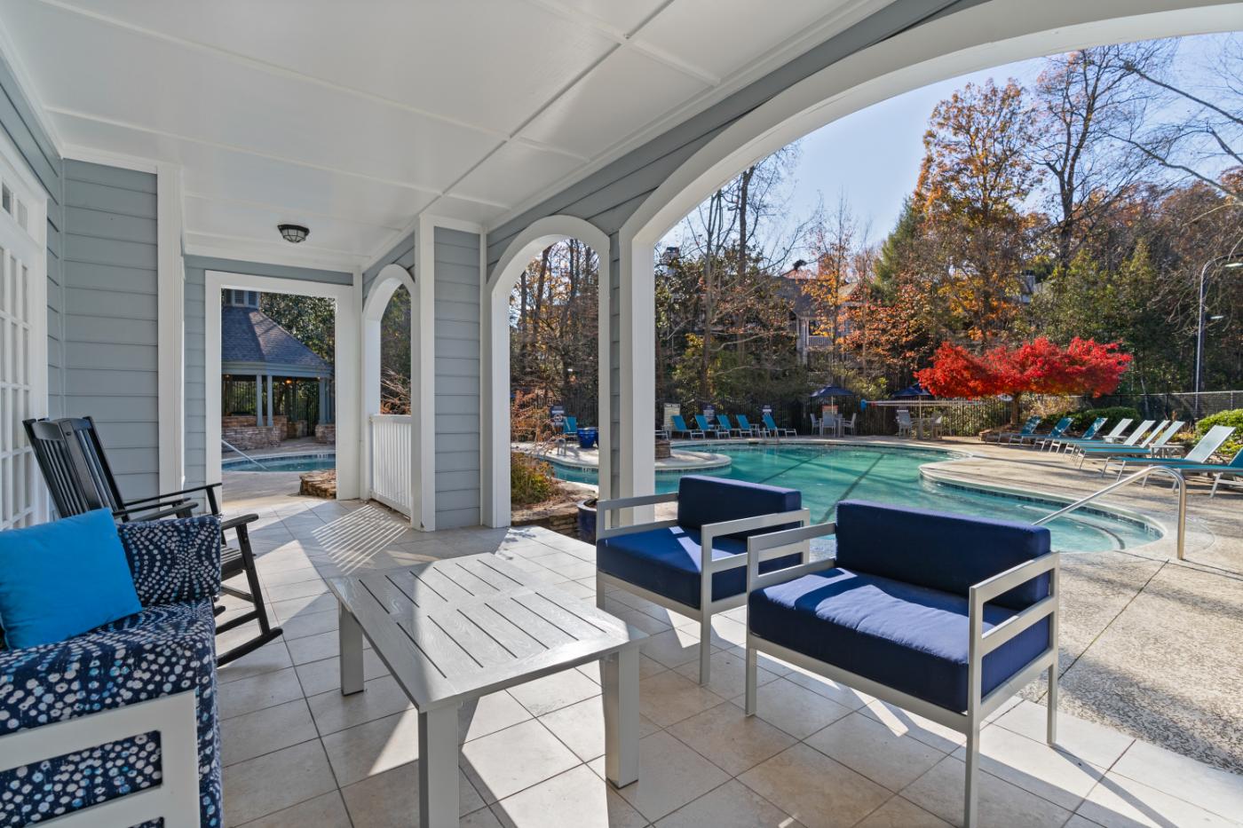 A poolside patio with a table and chairs.