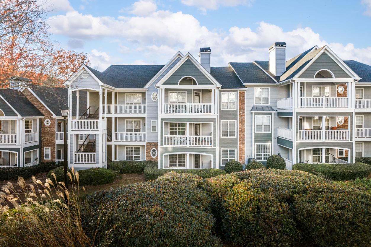 A row of apartment buildings with balconies and multiple stories.