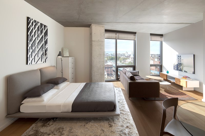 A bedroom with a large bed and a couch.