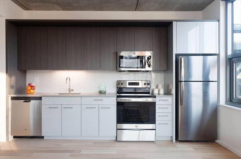 A modern kitchen with stainless steel appliances and white cabinets.