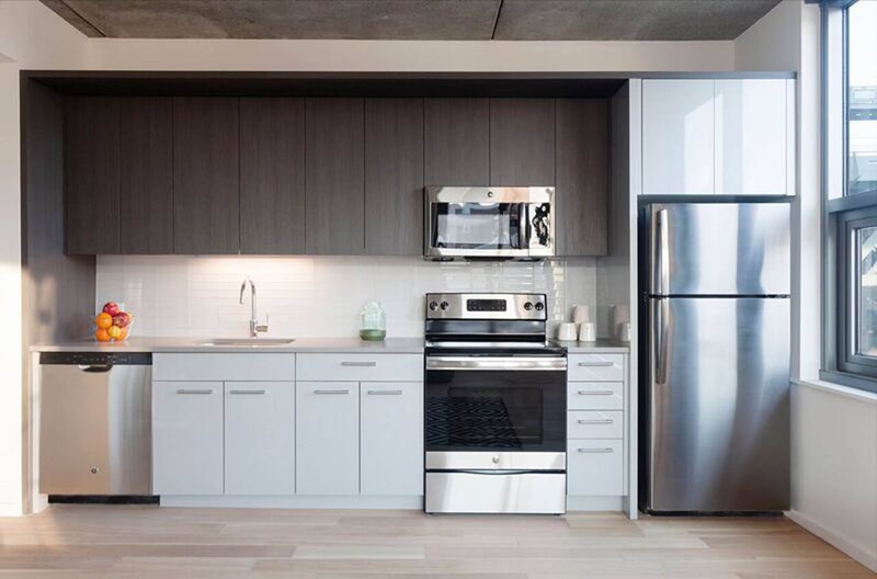 A modern kitchen with stainless steel appliances and white cabinets.