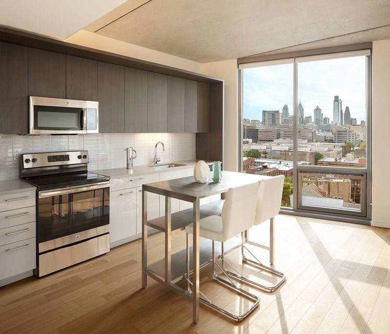 A modern kitchen with a view of the city.