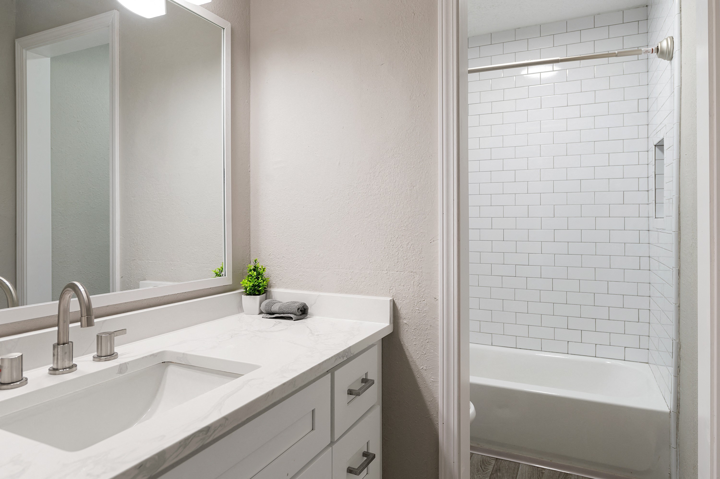 Apartment bathroom with sink and shower at Dunwoody Glen in Atlanta, GA.
