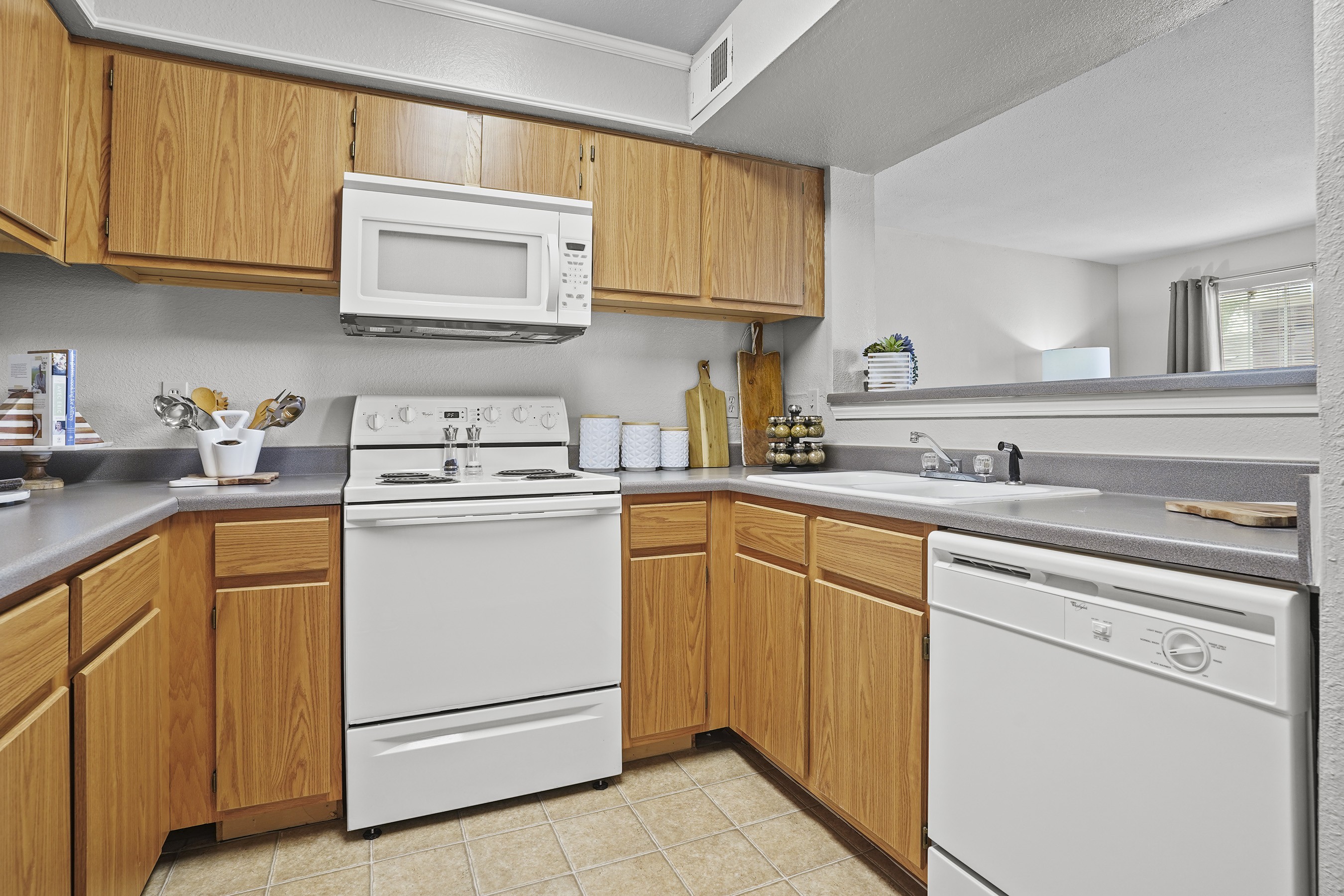 A kitchen with wooden cabinets and white appliances.