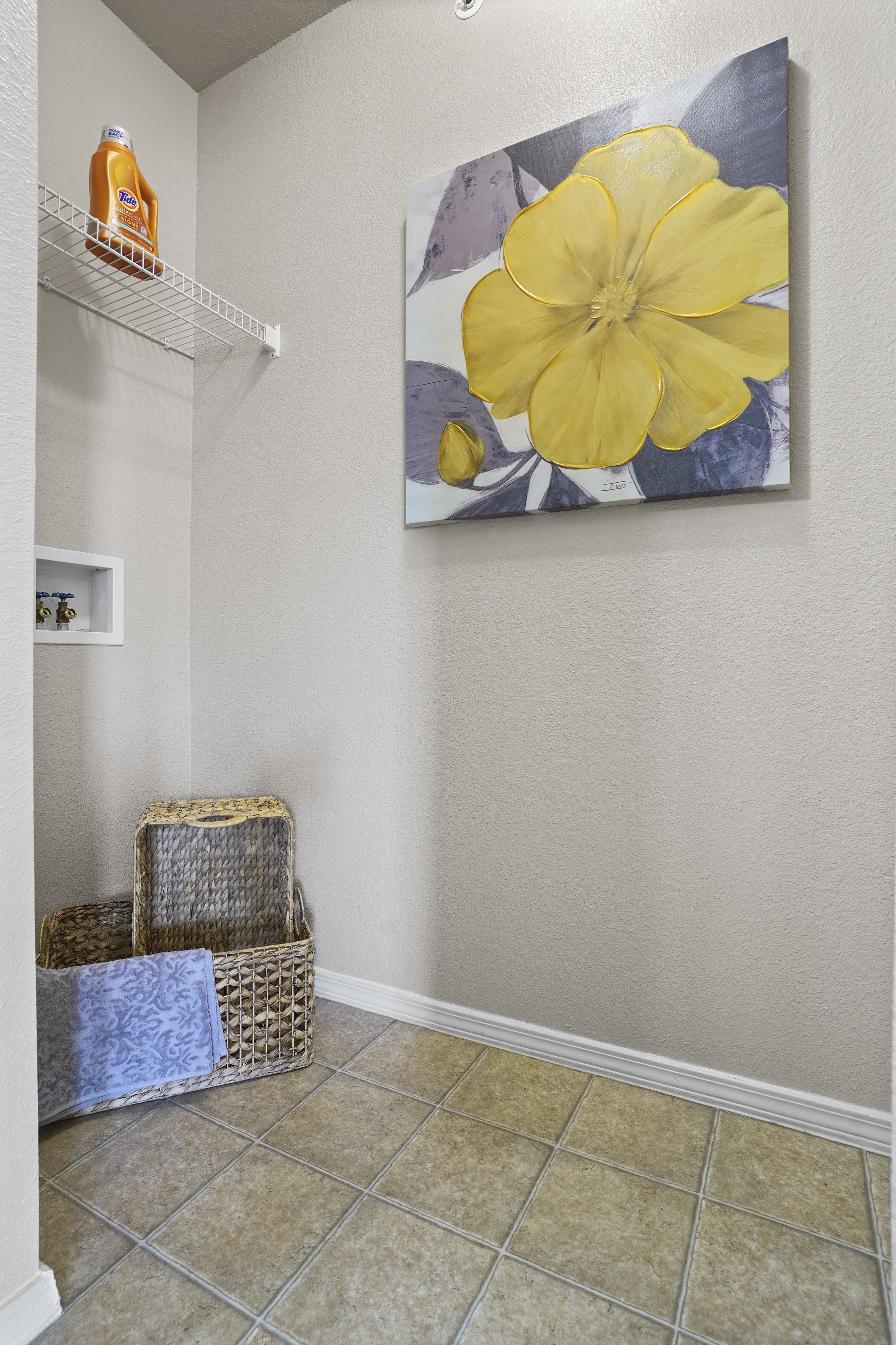 A yellow flower is painted on a canvas.