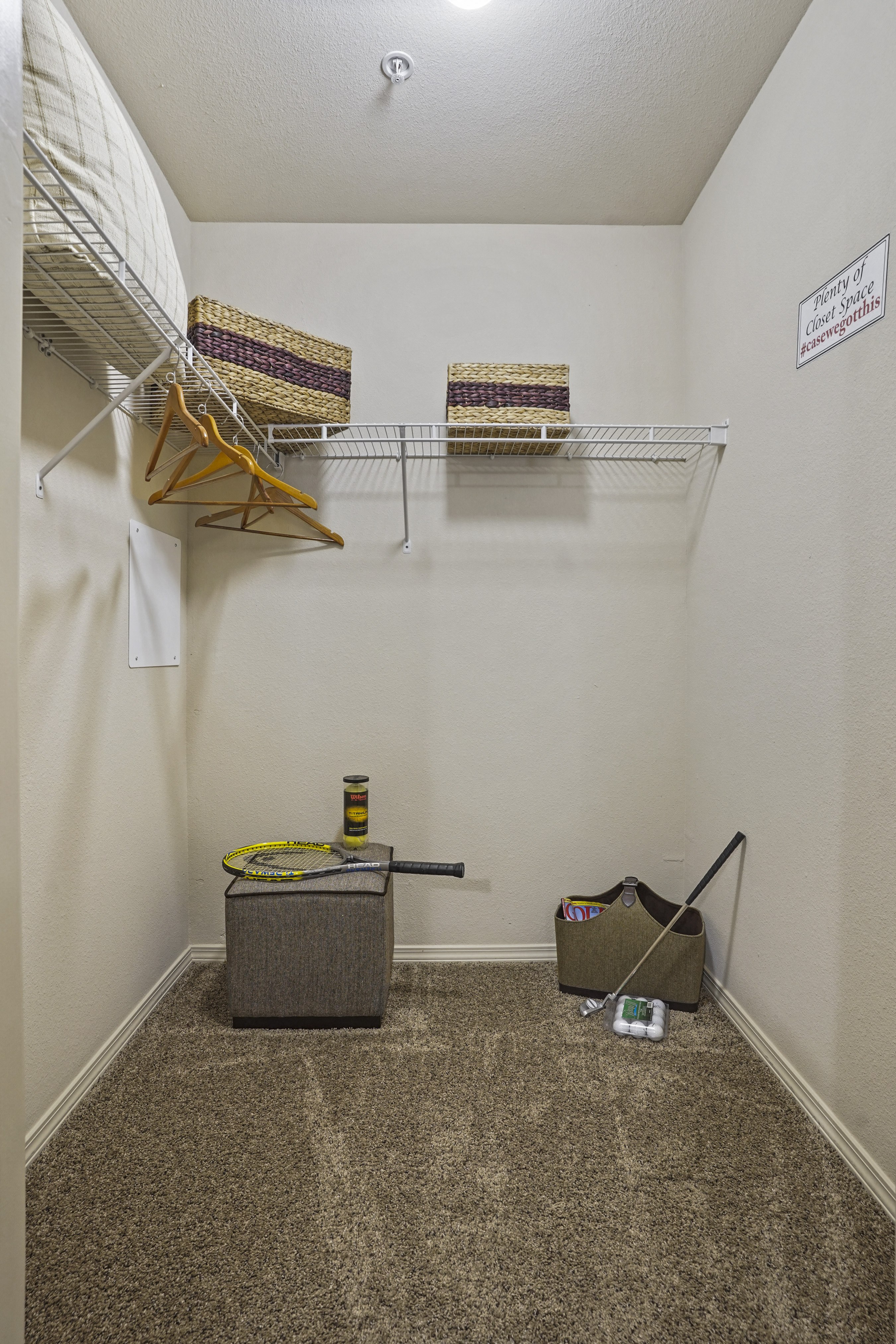 A room with a carpeted floor and a sign on the wall.