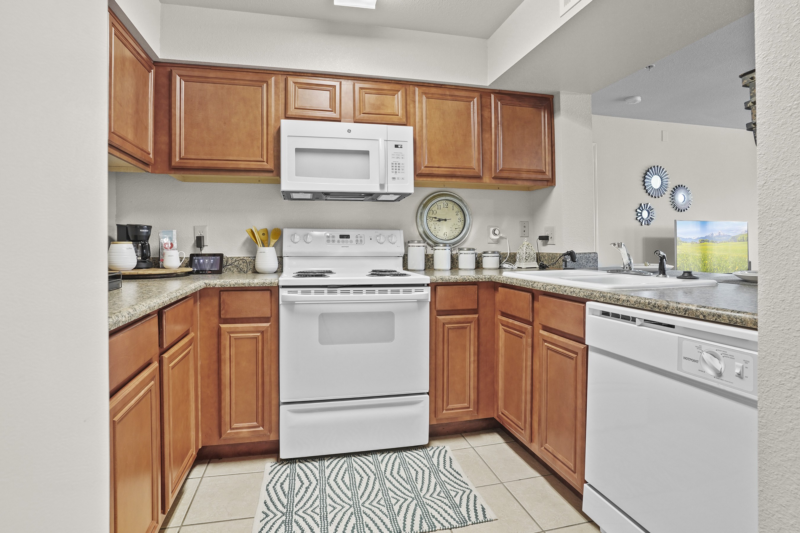 A kitchen with wooden cabinets and a white oven.