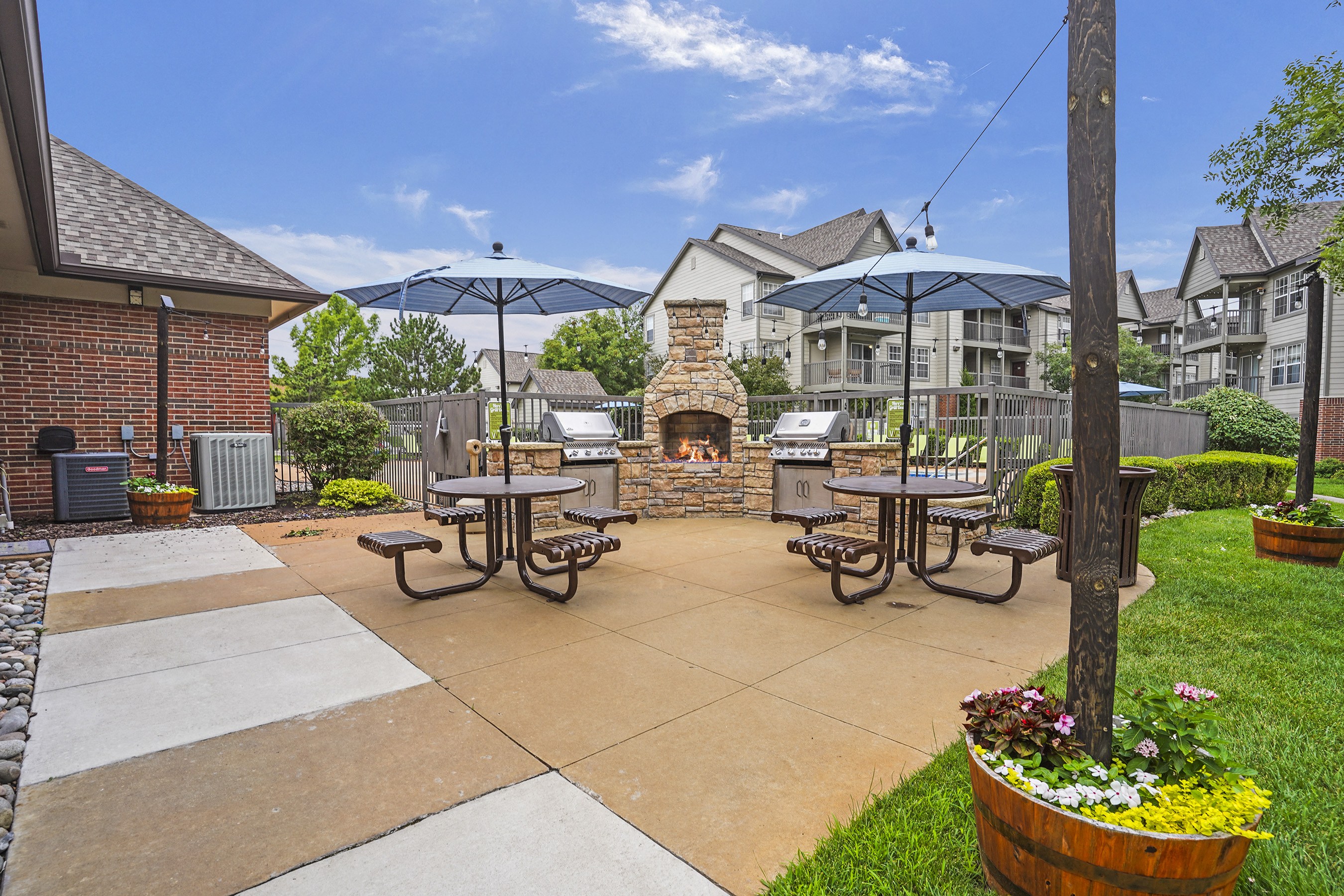 A patio with a fireplace and seating area.