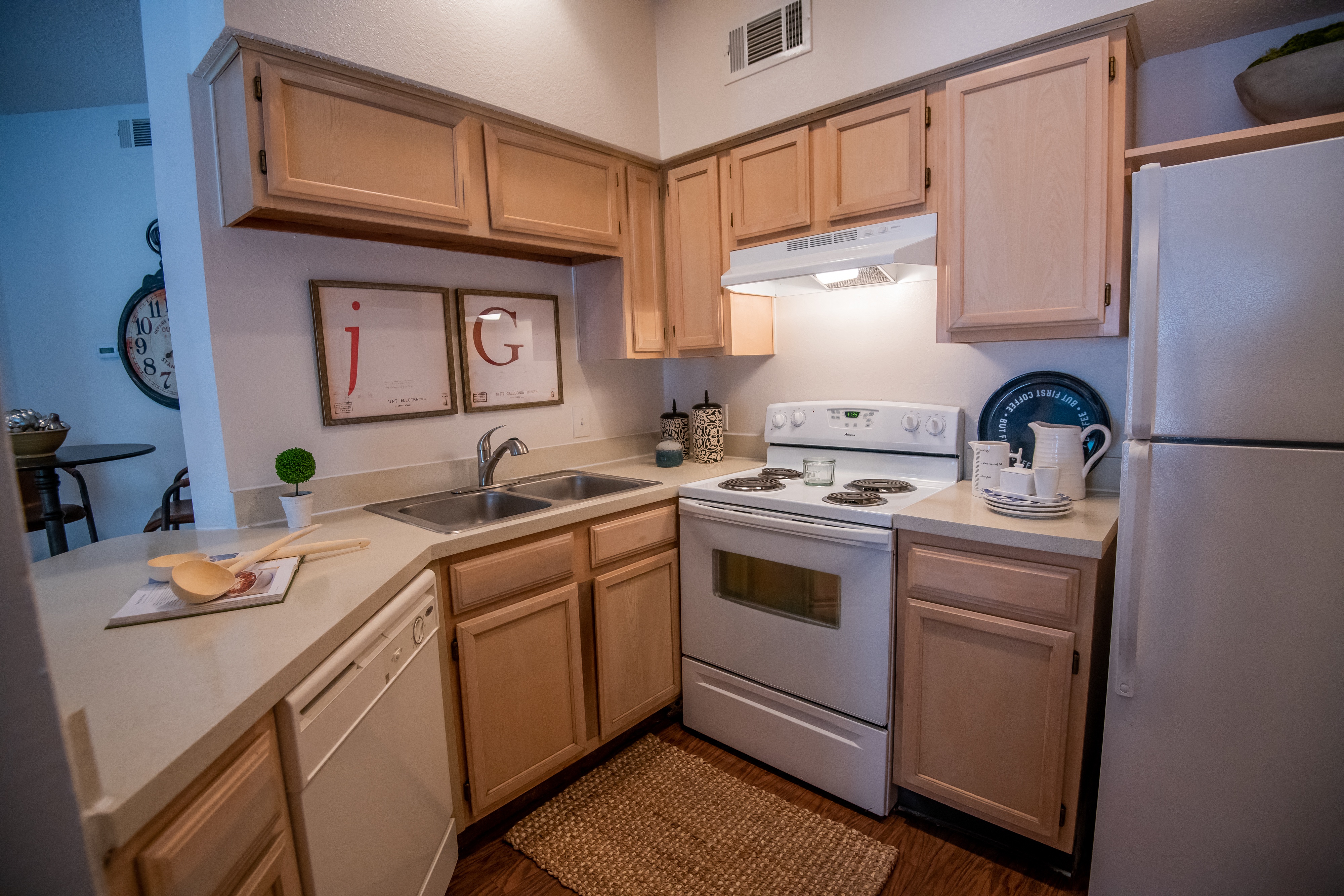 A kitchen with wooden cabinets and white appliances.