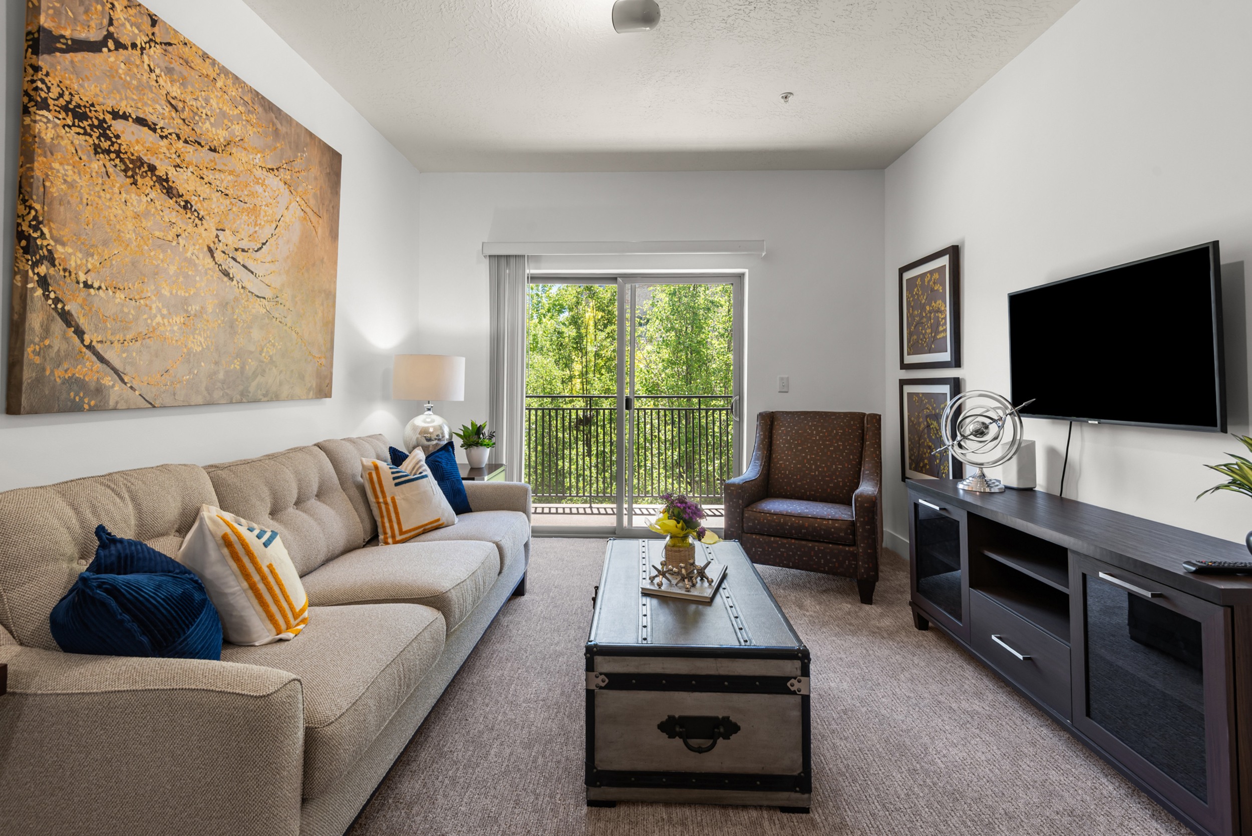 Living room with balcony and modern furnishings at Liberty Gateway Apartments, Salt Lake City