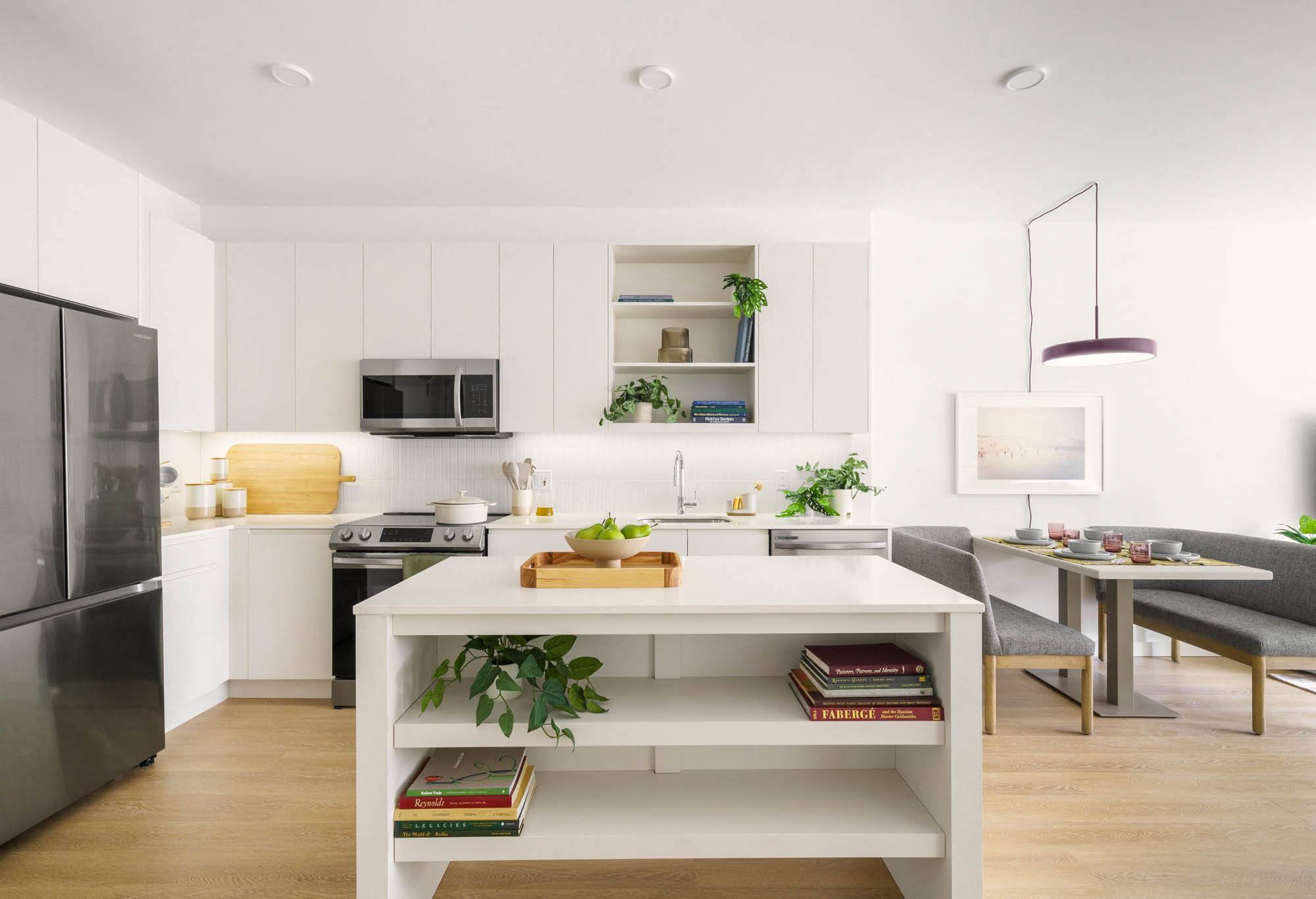 an open kitchen and dining area with a table and chairs,,a rendering of a living room with a table and chairs,a white kitchen with a white island and a stainless steel refrigerator,