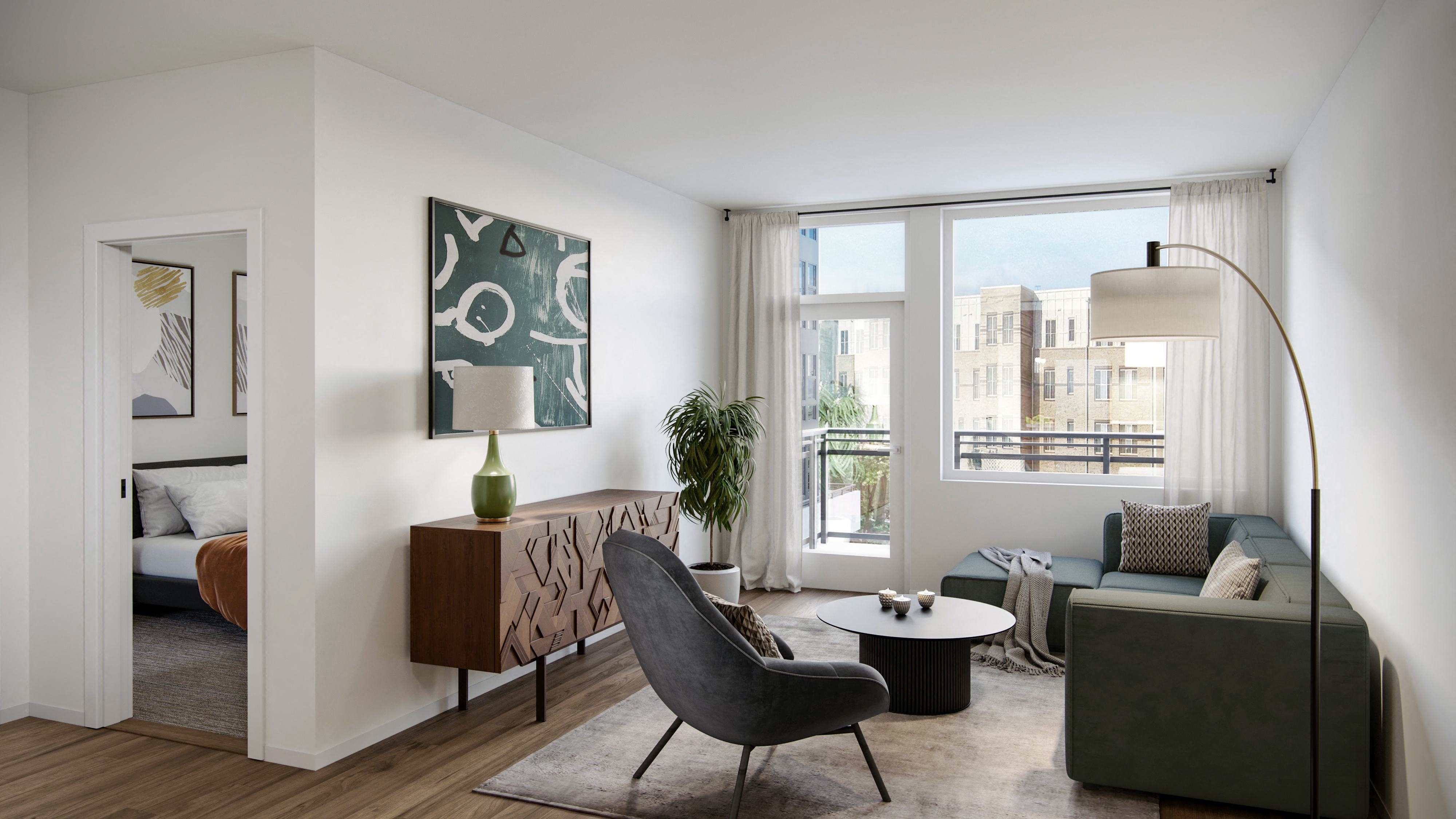 a living room with a large window and a door that leads to a balcony