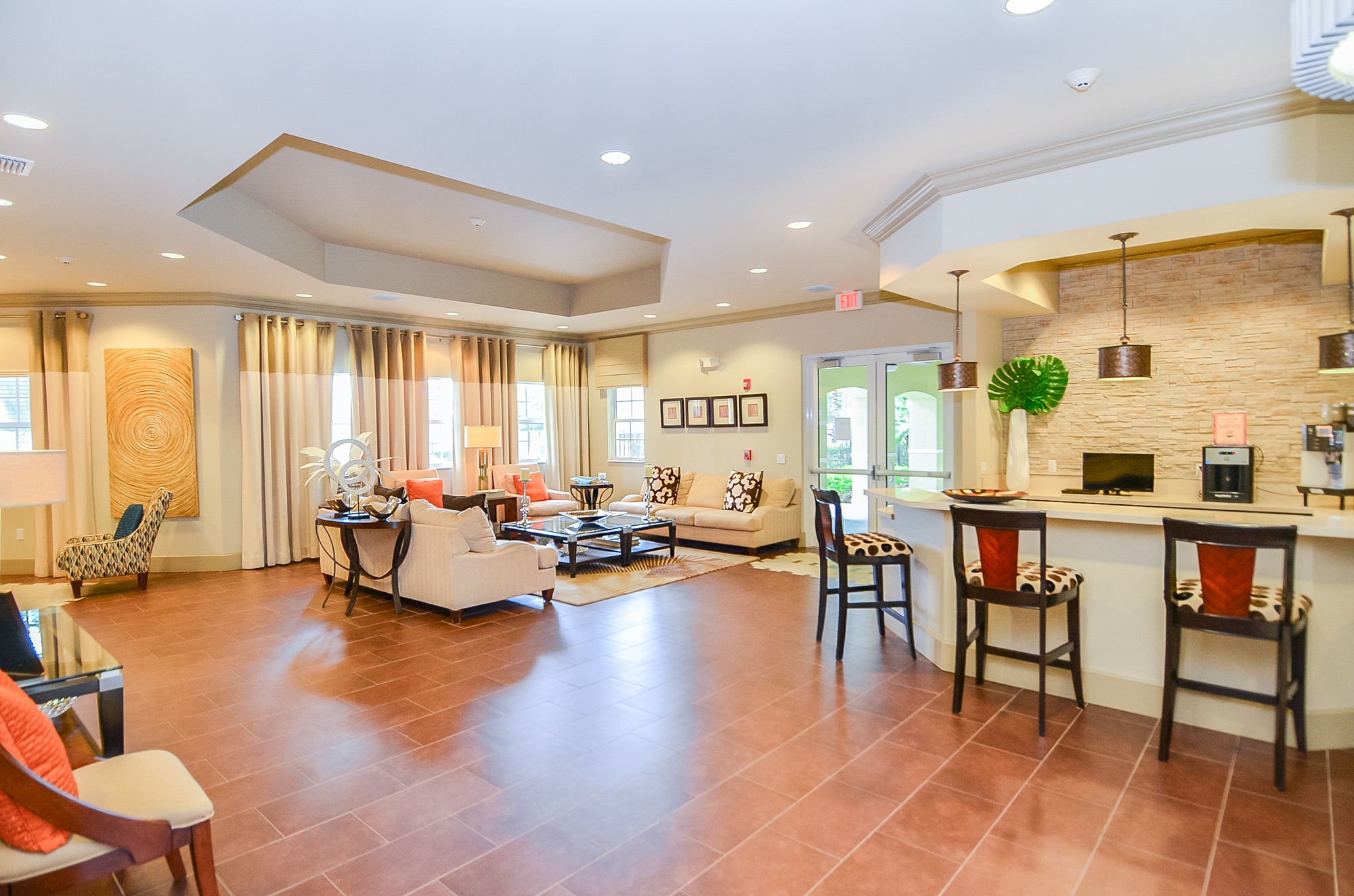 A living room with a kitchen area in the background.