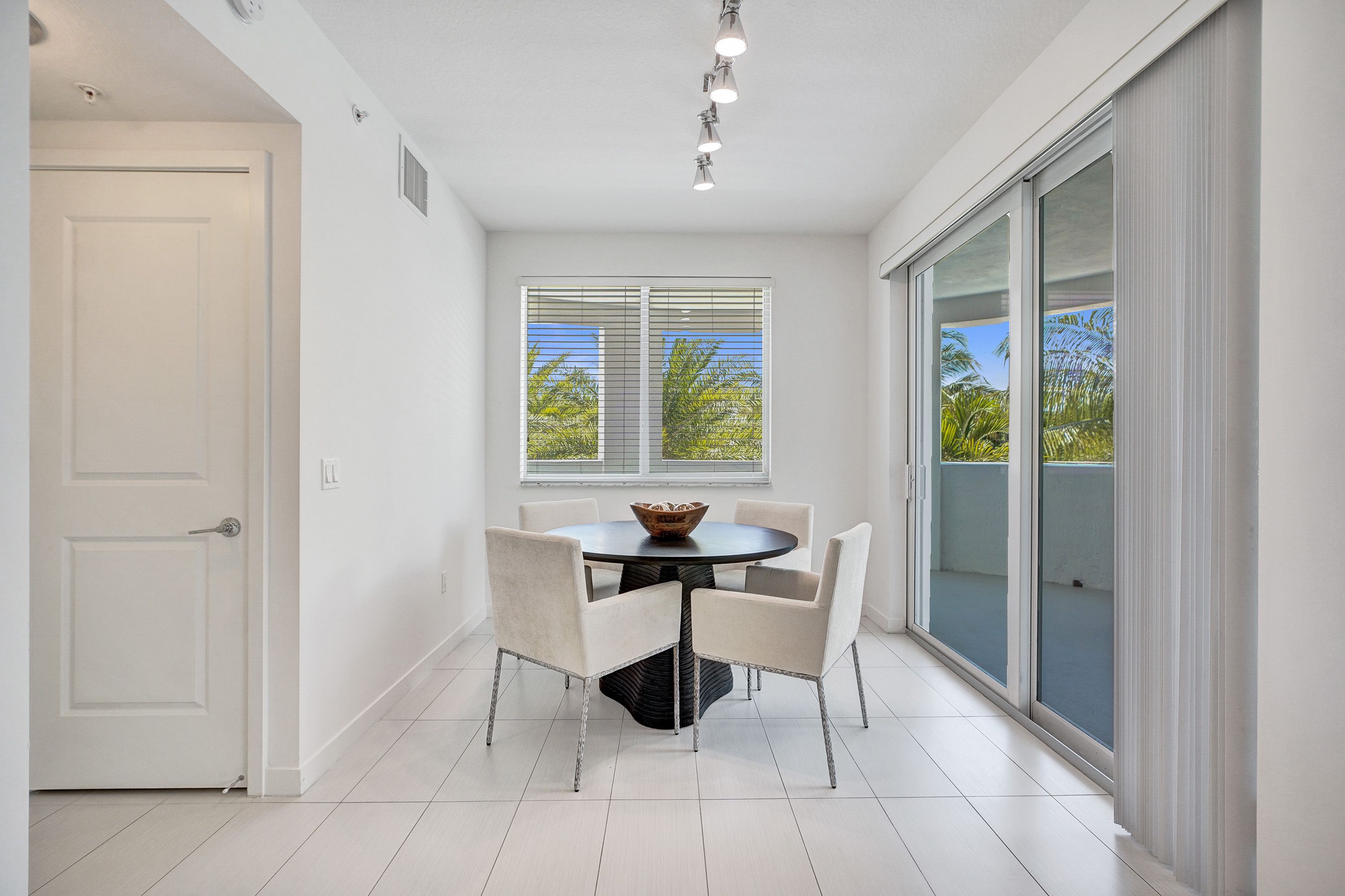 A dining room with a table and chairs.