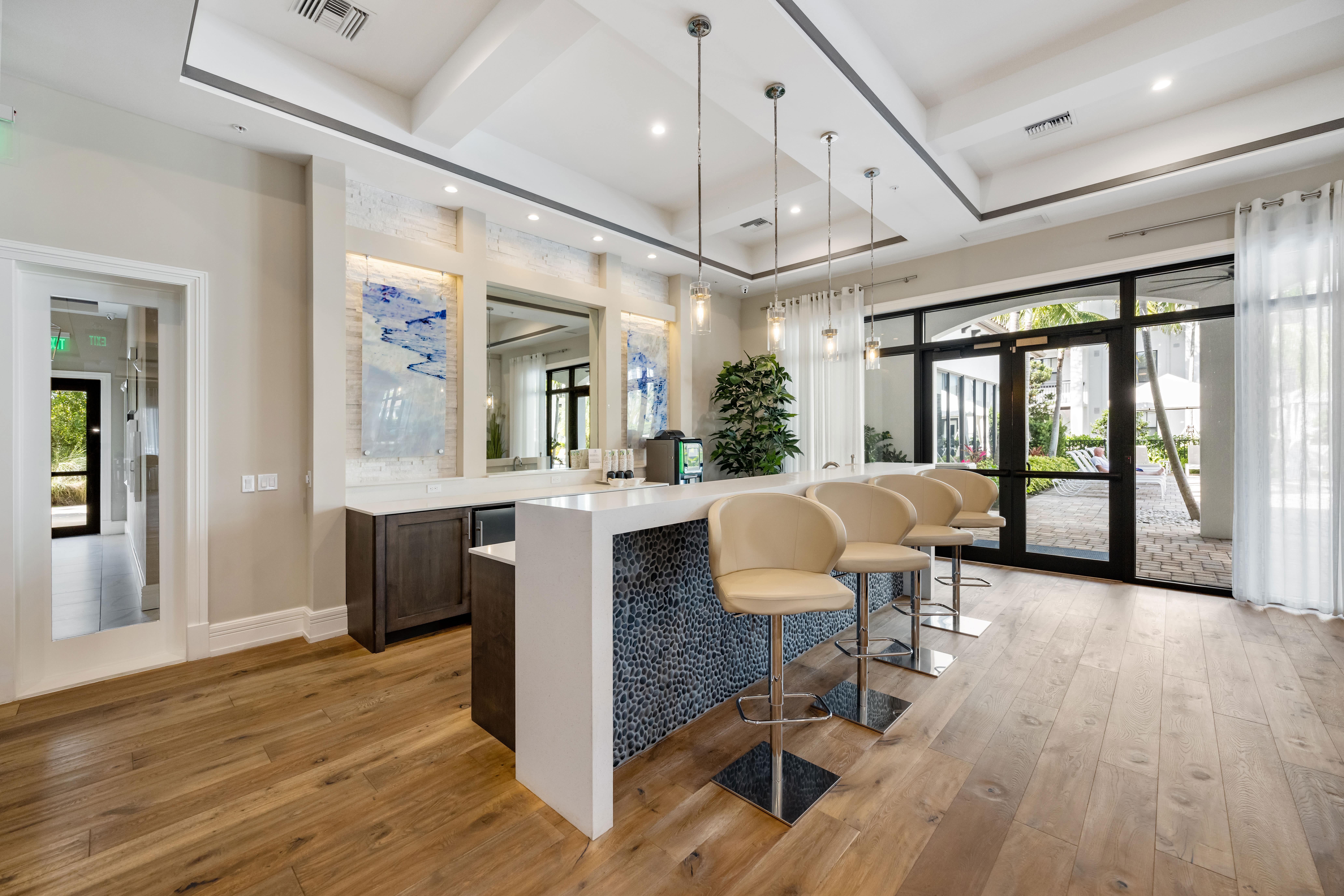 A modern bar area with a counter and chairs.