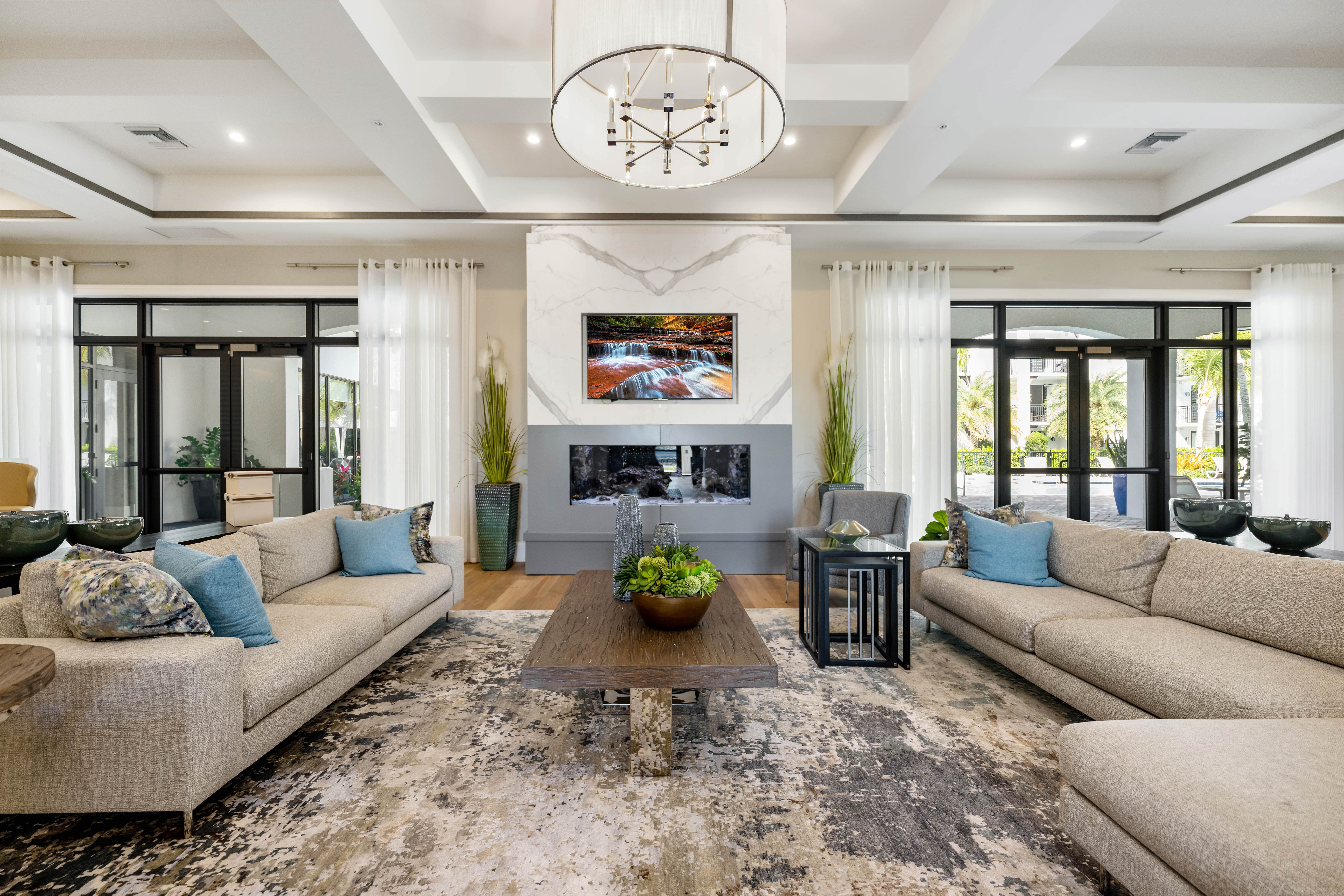 A modern living room with a large rug, two couches, and a coffee table.