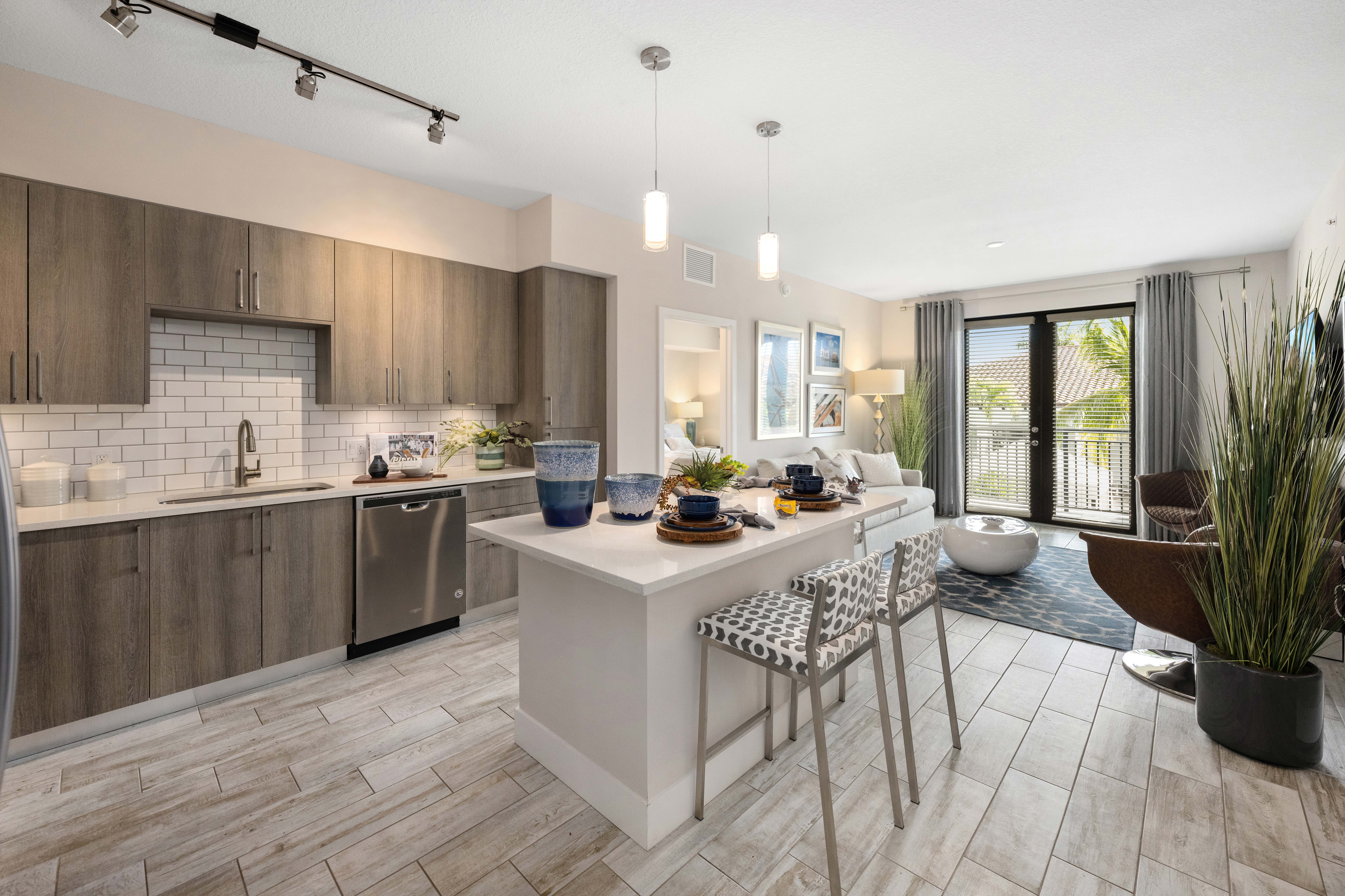 A modern kitchen with a dining table and chairs.