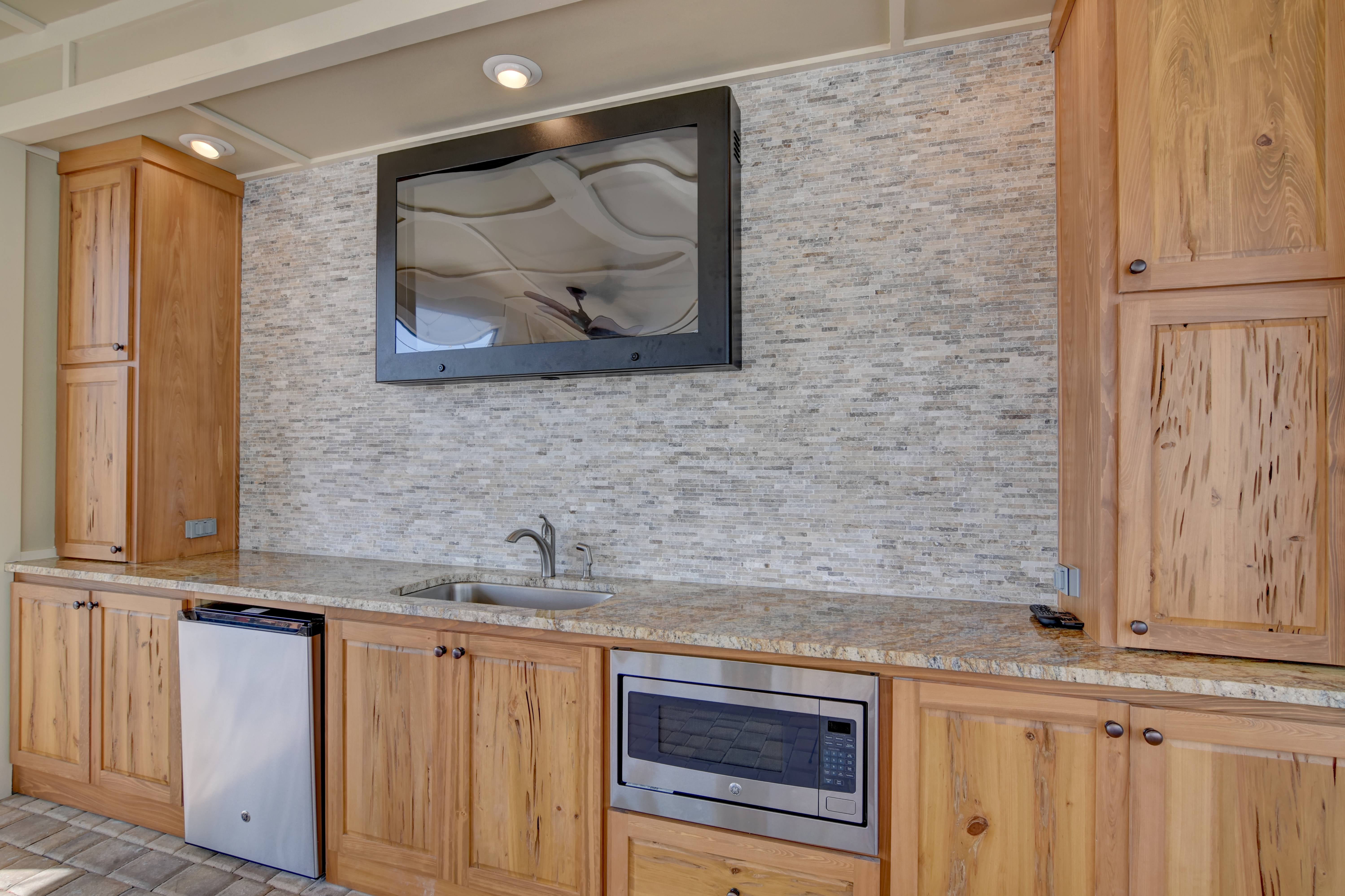 A kitchen with wooden cabinets and a granite countertop.
