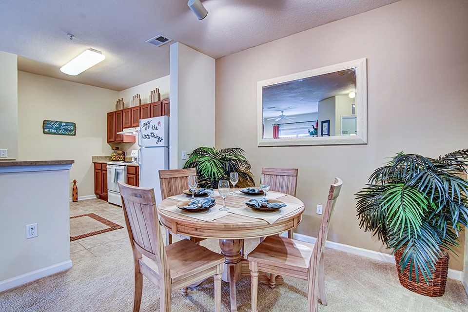 A dining room with a table set for six.