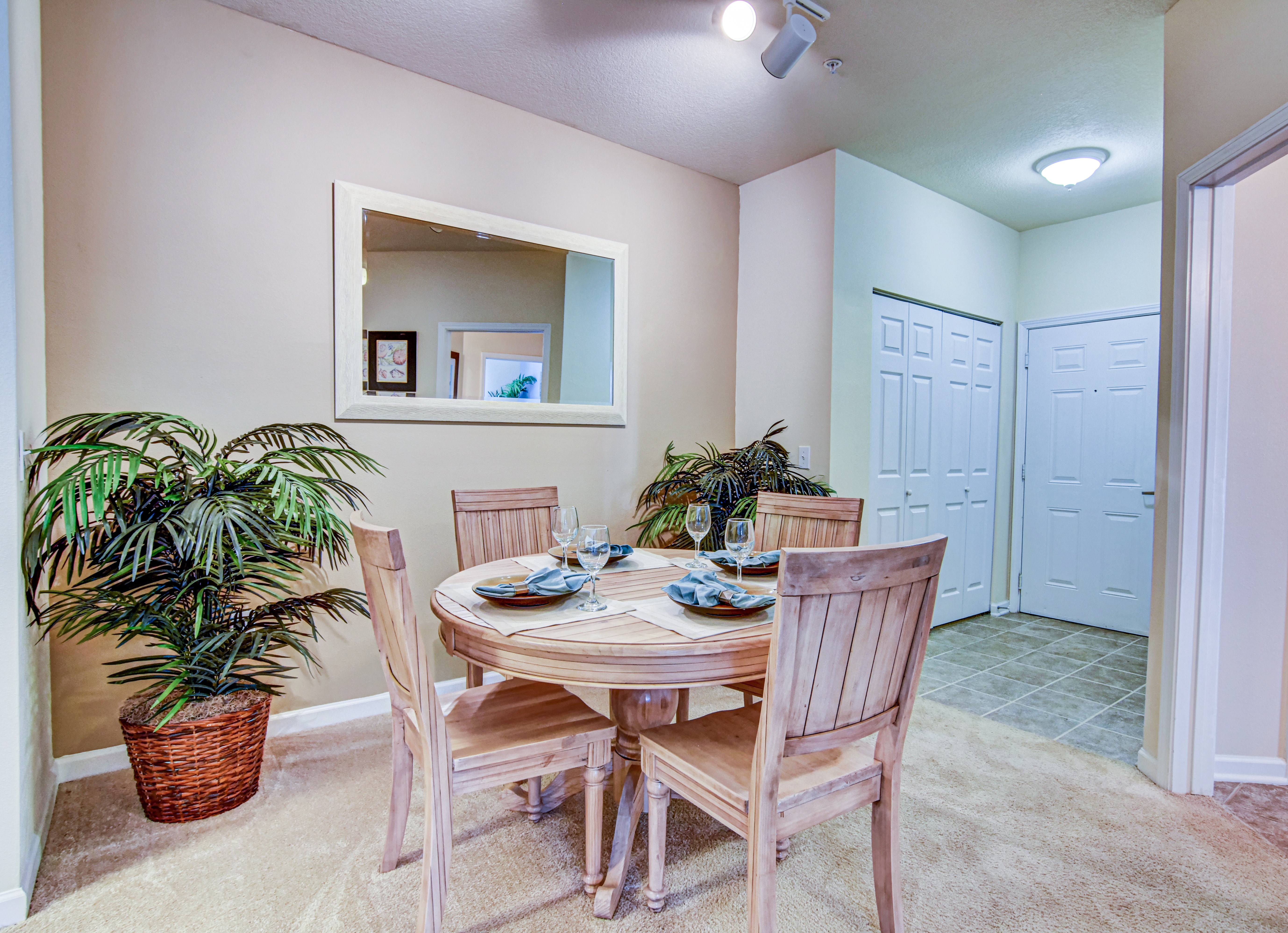 A dining room with a round table and chairs.