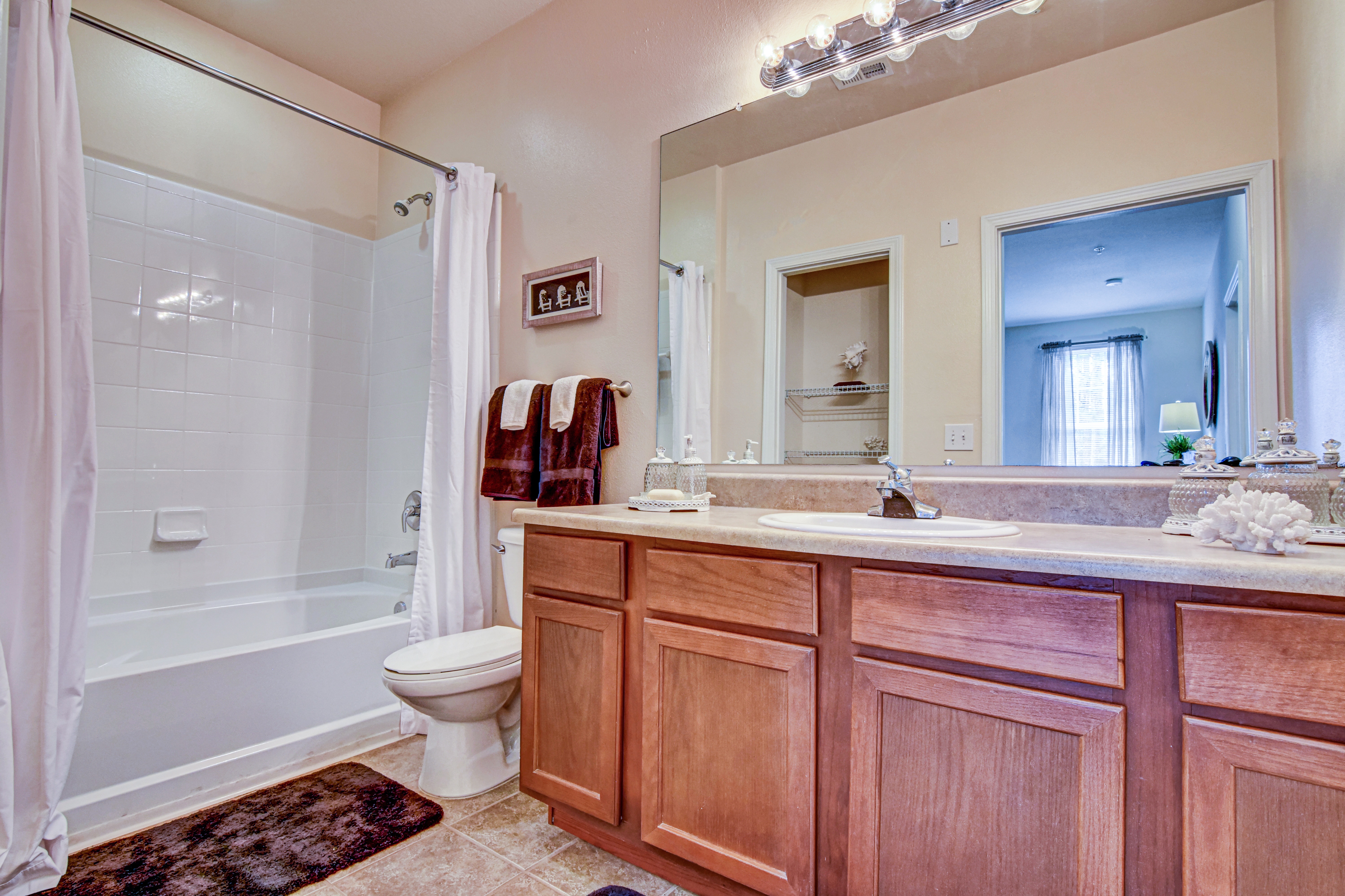 A bathroom with a toilet, sink, and shower.